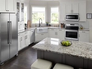 Suite of stainless steel Maytag® kitchen appliance in white cabinetry