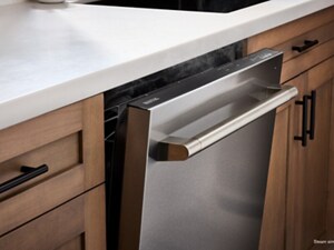 A stainless steel dishwasher with a bar handle open a few inches as steam comes out