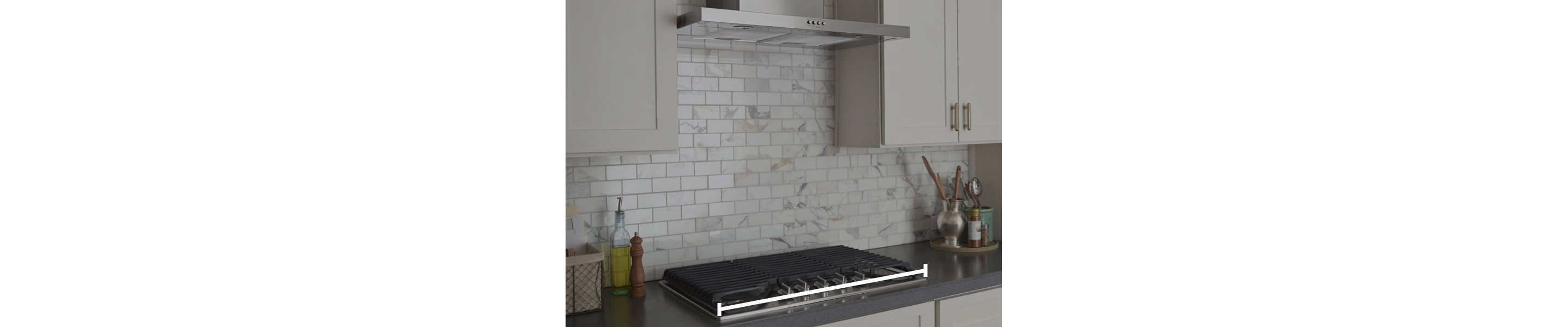 Range hood over cooktop with marks showing how to measure horizontally