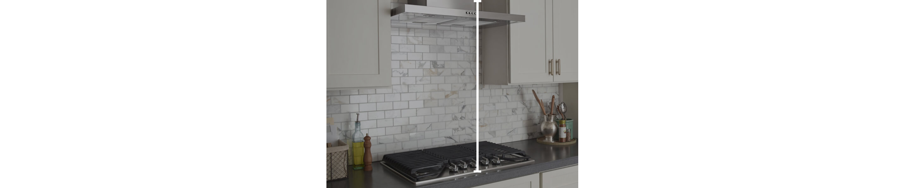 Range hood over cooktop with marks showing how to measure vertically