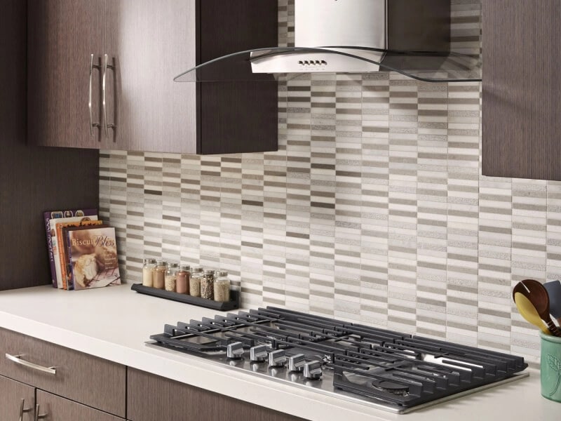 Kitchen with brown cabinets and stainless range hood