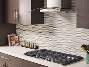 Kitchen with brown cabinets and stainless range hood