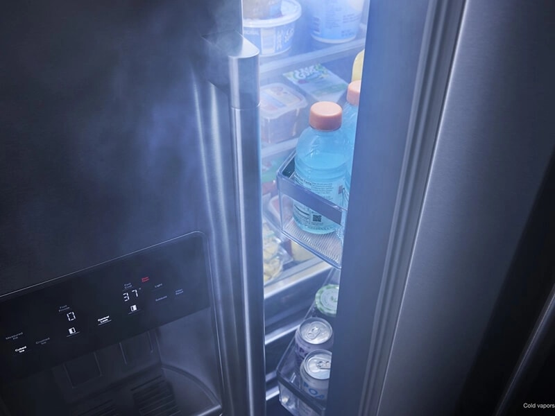 Cool air flowing out of cracked open refrigerator door