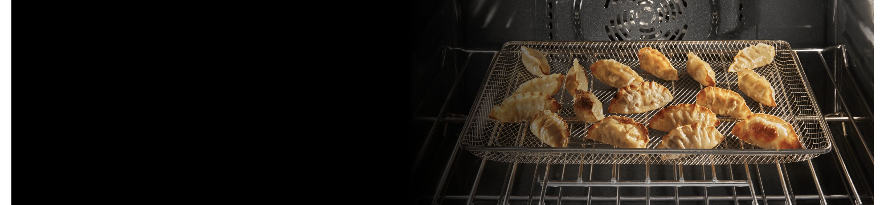 Several potstickers in a basket inside an oven