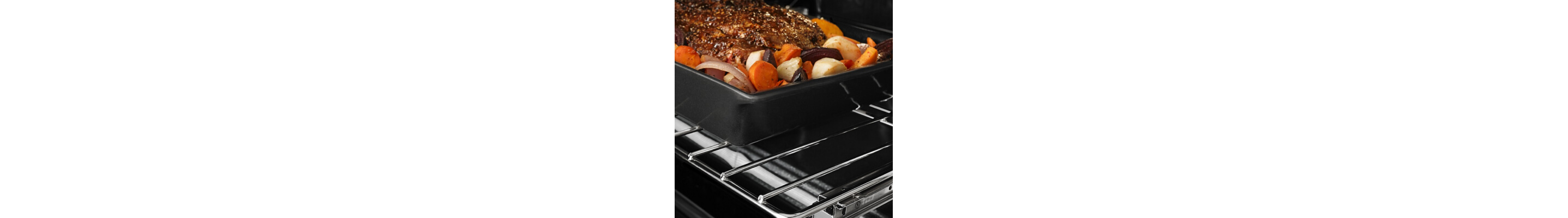 Meat and veggies in a pan on an oven rack