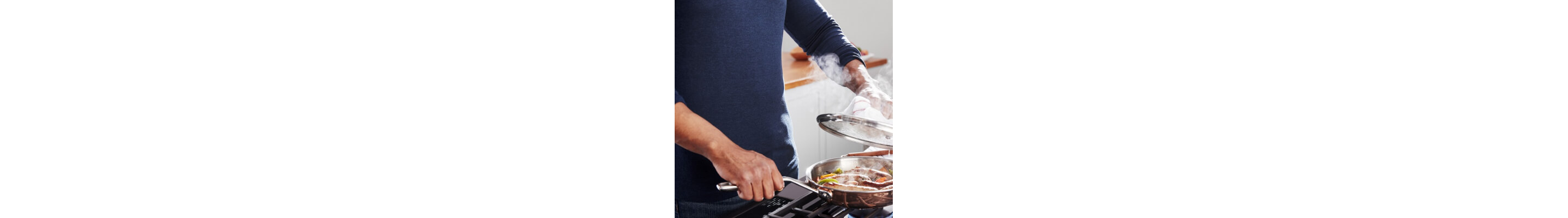 A person sauteing at a stove
