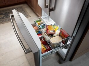 A bottom freezer open to show its contents