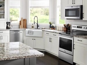 Maytag® electric range in white cabinetry below over-the-range microwave
