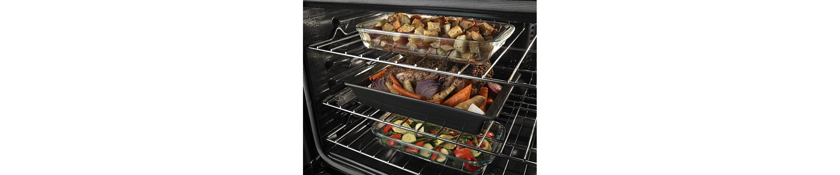 Closeup of food cooking on multiple racks