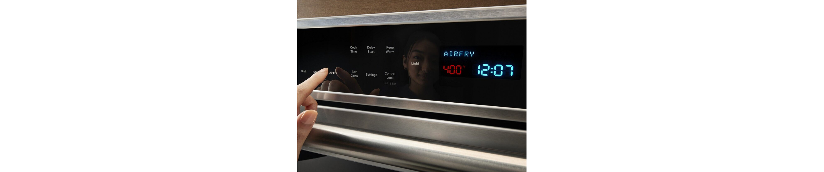 Hand selecting an oven setting