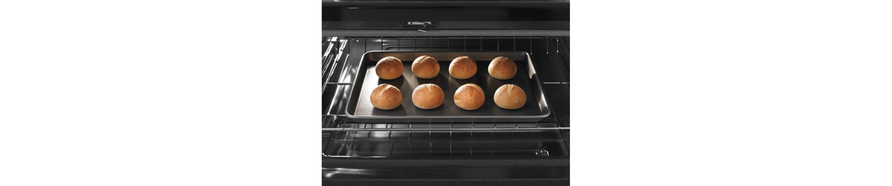 Small bread loaves on a baking sheet and in an oven