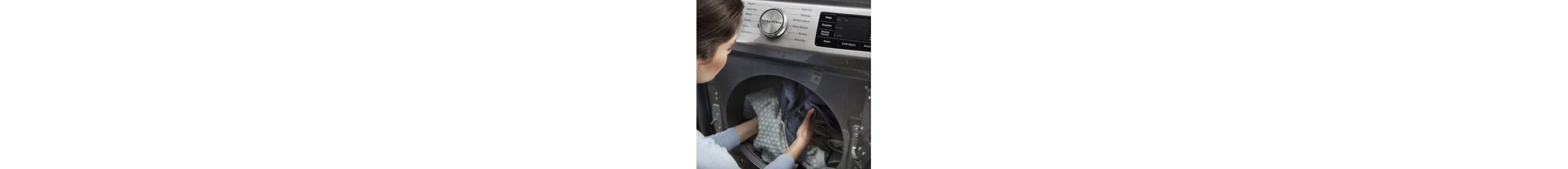 Person loading laundry into a front load dryer