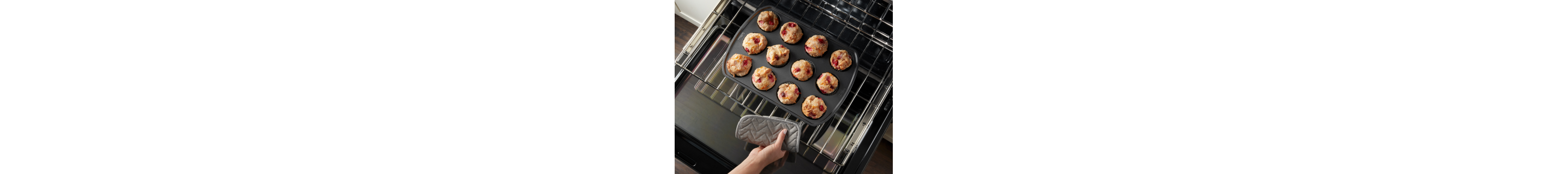 Person removing baked goods from an oven