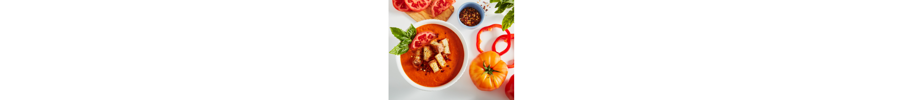Tomato soup in a bowl with garnishes