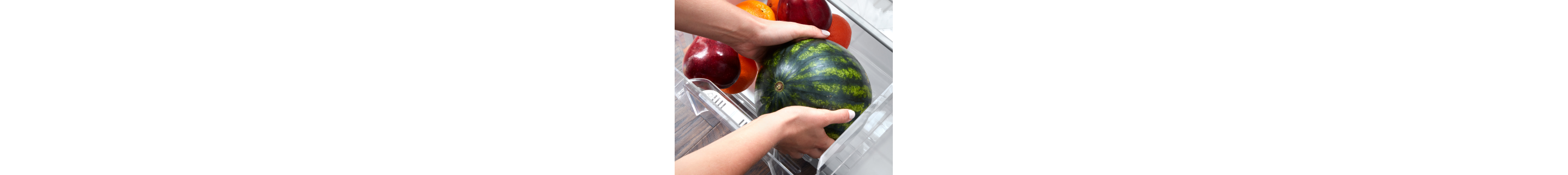 Person placing watermelon in a refrigerator