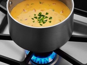 Pot of soup on a gas cooktop