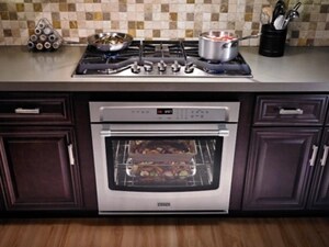 Wall oven installed in cabinets beneath a gas cooktop