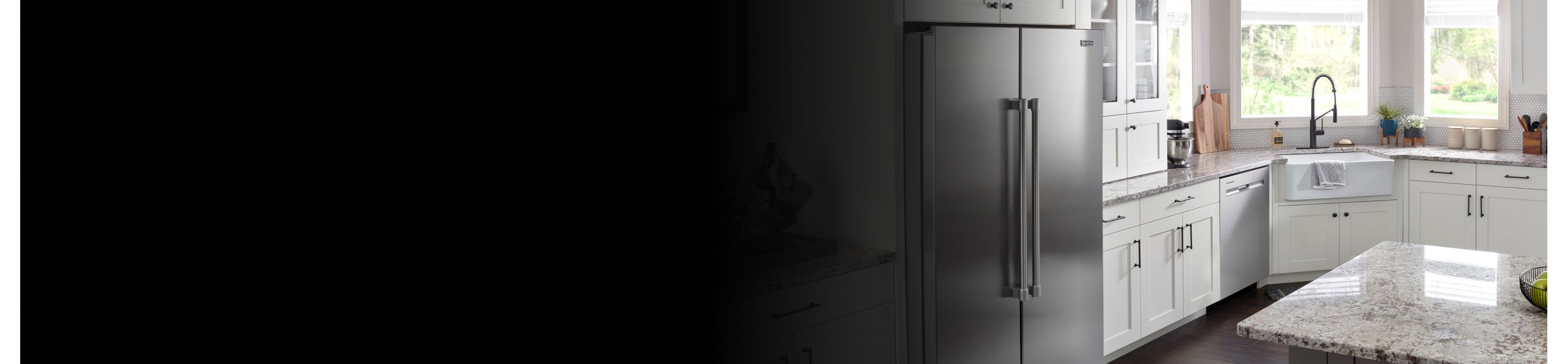 Stainless steel side-by-side refrigerator in white cabinetry 