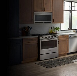The interior of a kitchen with wood cabinetry and a gas stove