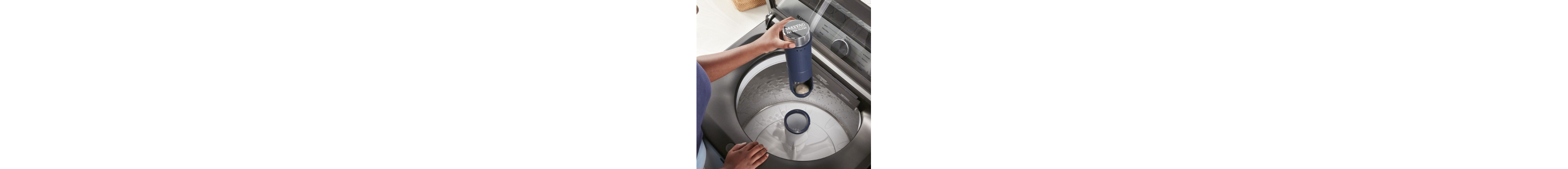 A person taking the Pet Pro Filter out of washing machine agitator