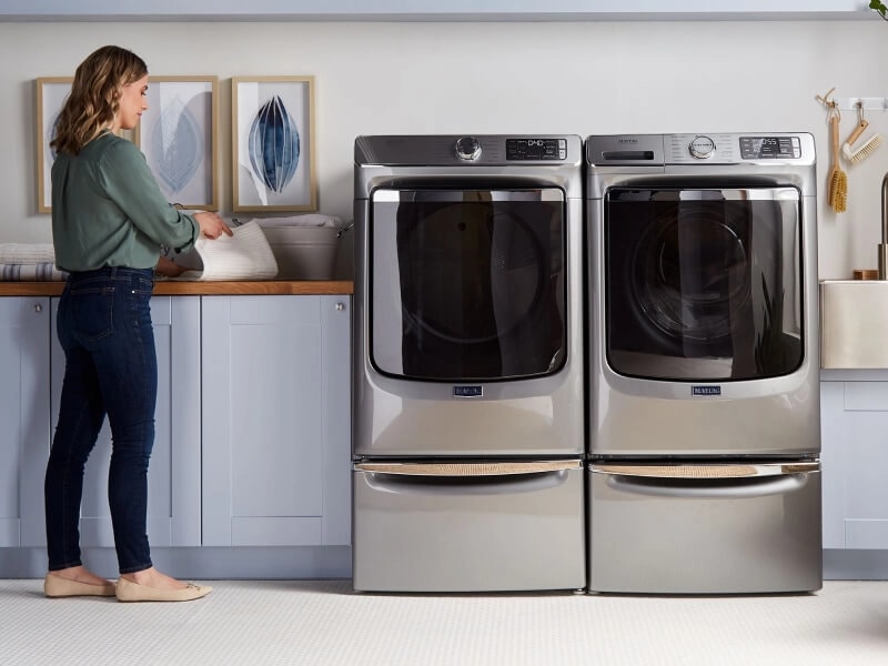 Maytag® front load washer and dryer on laundry pedestals