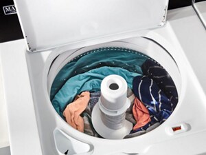 Clothing loaded into an open top load washer
