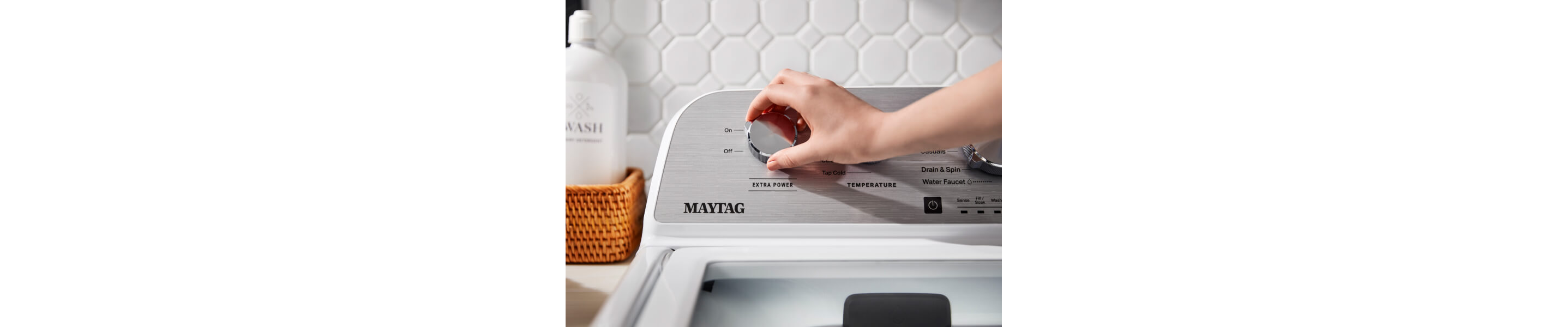 Person selecting a wash cycle on a Maytag® top load washer