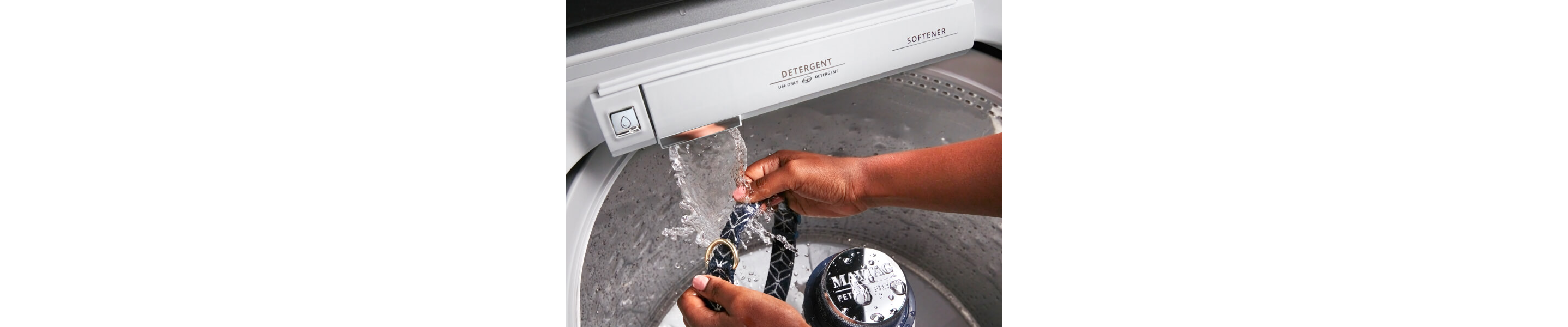 Person cleaning a belt using a Maytag® washing machine with Built-In Water Faucet
