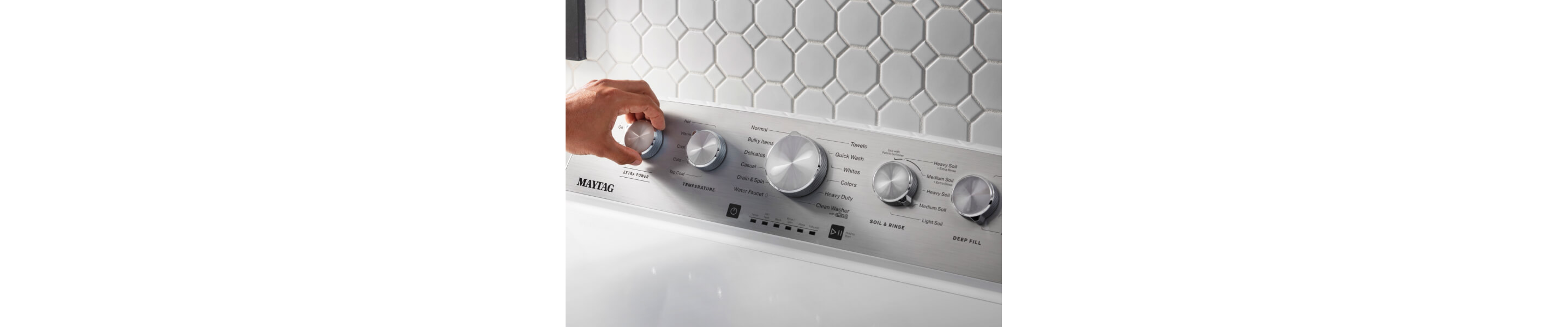 Person selecting a cycle setting on a Maytag® washing machine