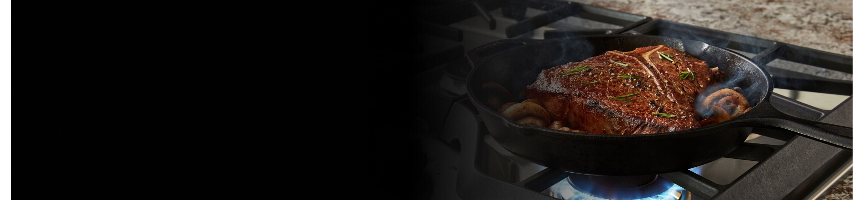 Steak cooking on a gas range