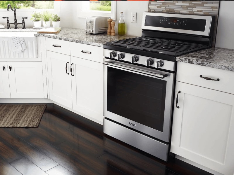 A Maytag® oven in a kitchen with white cabinets
