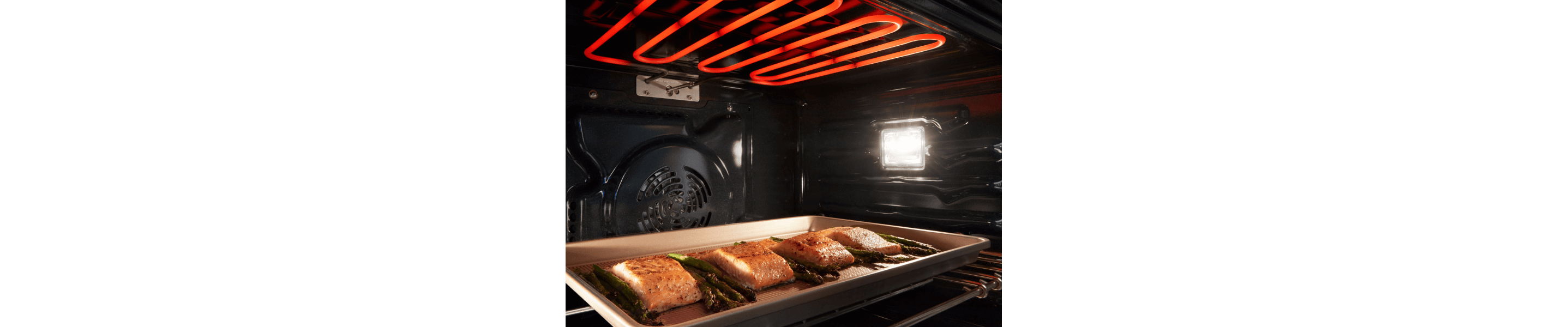 Fish and asparagus broiling in an oven