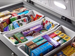 An open chest freezer, filled with food
