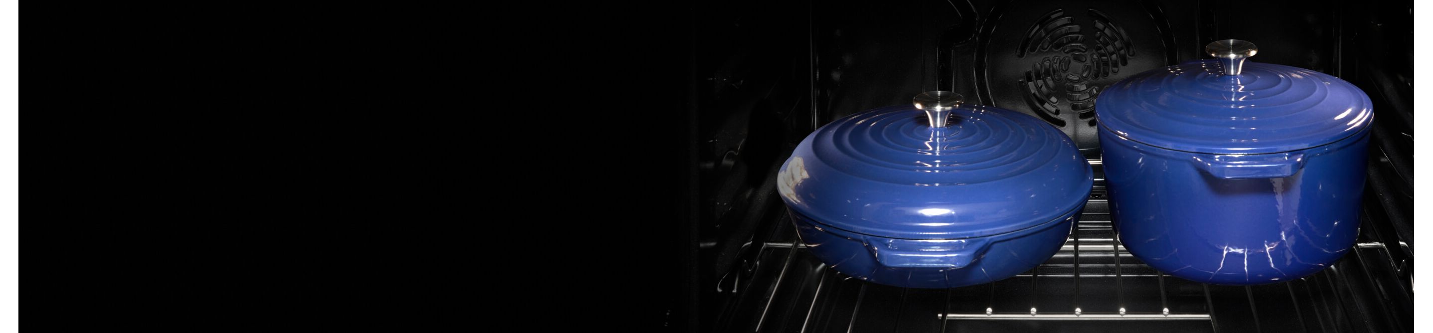 Two covered blue ceramic pots on an oven rack