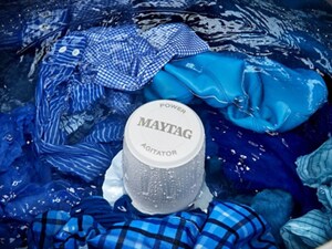 Maytag brand Washer with water and blue clothes