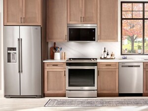 Maytag® stainless steel kitchen appliance suite in brown cabinetry