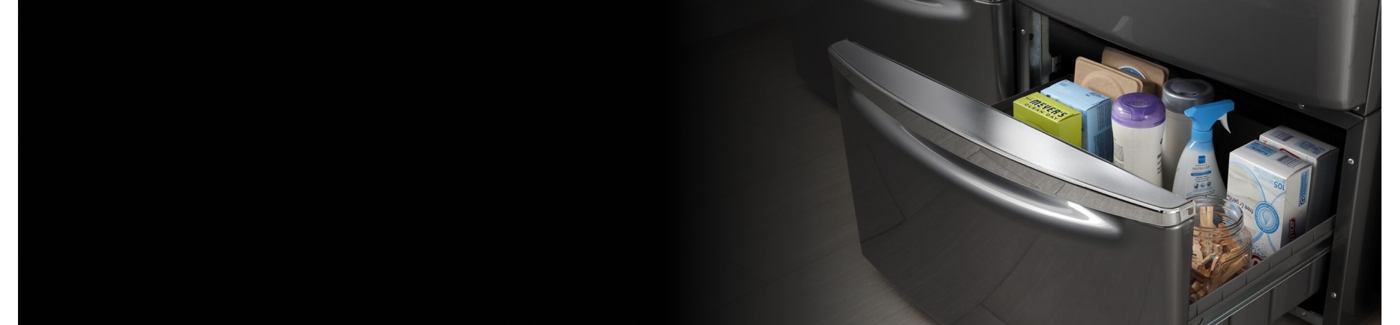 Close-up of open laundry pedestal drawer with laundry supplies inside