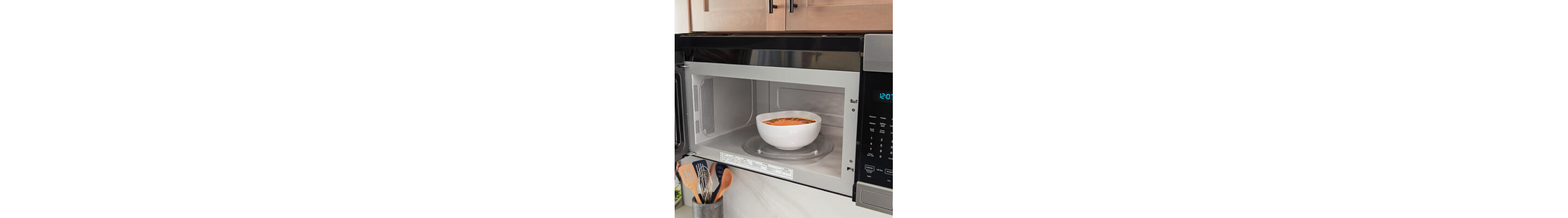 Bowl of soup inside an open microwave