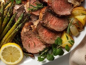 Sliced steak with potatoes and veggies on a plate