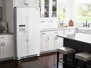 A white fridge in a bright, white kitchen