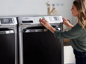 Person selecting settings on a Maytag® front load washer