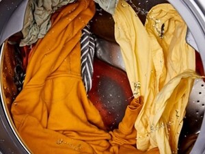 Wet clothes rotating inside a washer drum