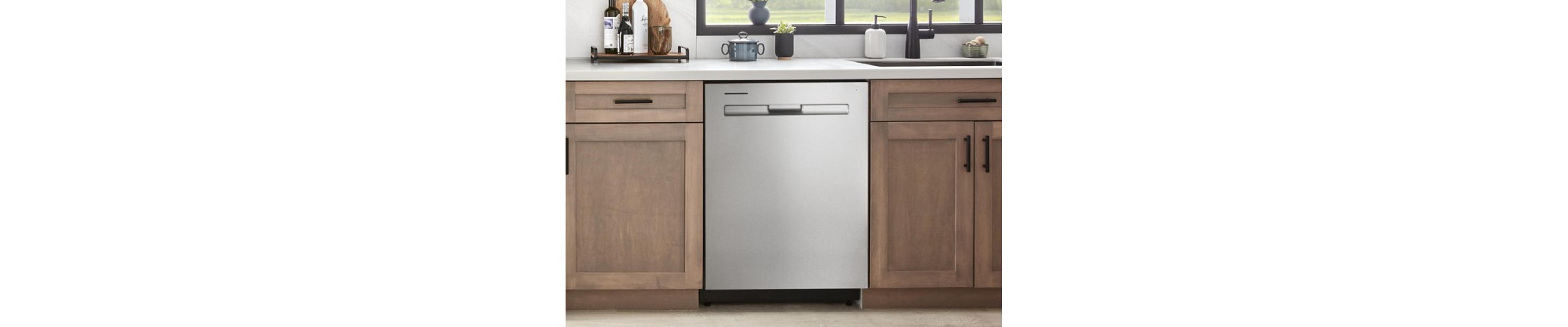 A Maytag® dishwasher in a kitchen with light brown cabinets