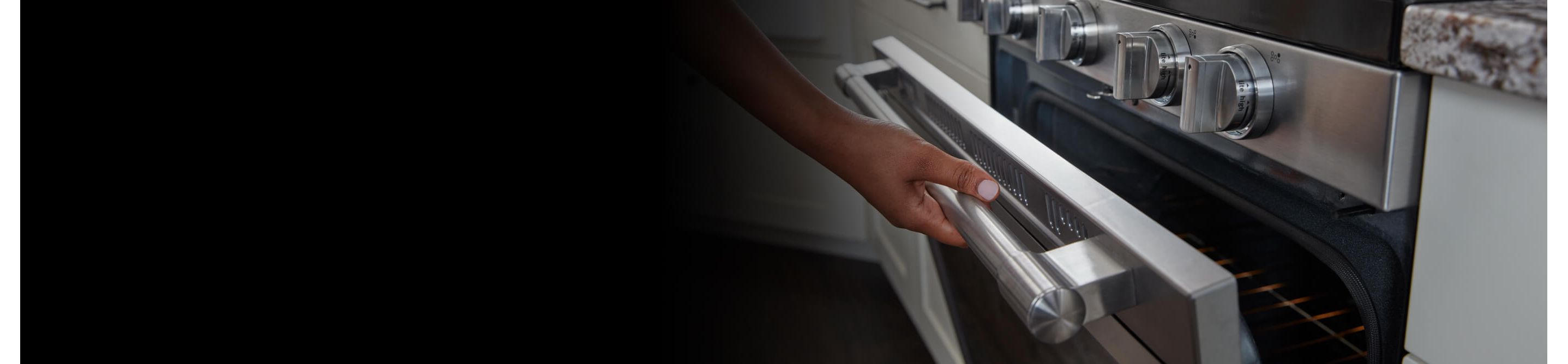 Person cracking open the door of a gas oven