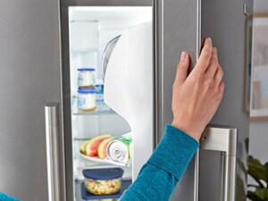 A close-up of someone opening their refrigerator door
