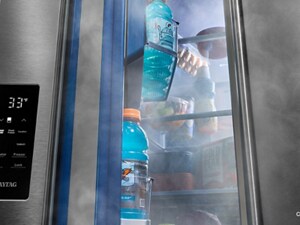 A slightly open fridge door showing drinks in the door