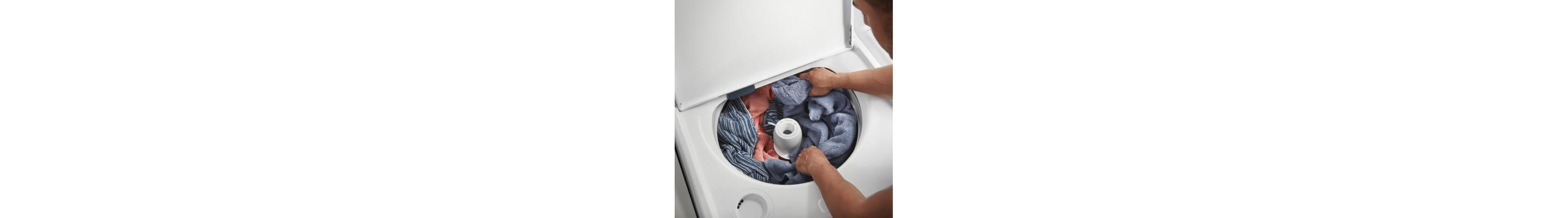 Person arranging laundry around an agitator