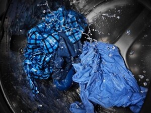 Blue clothing being cleaned in a washing machine
