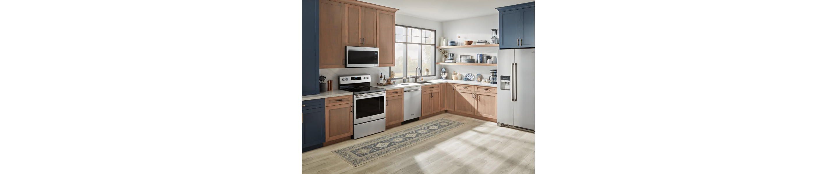 A Maytag® stove, over-the-range microwave, dishwasher and refrigerator in a modern kitchen