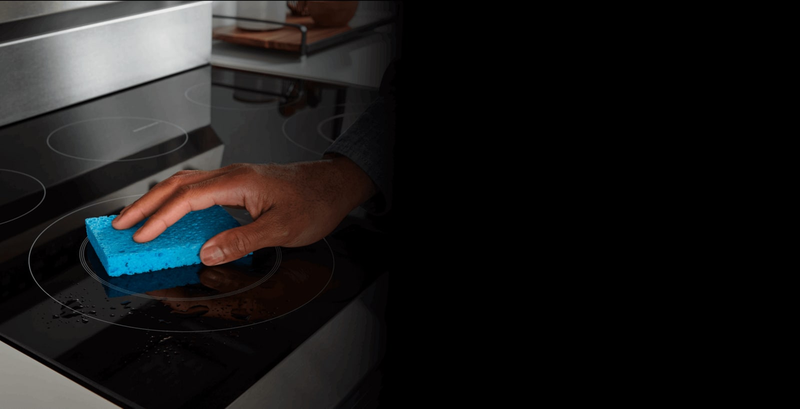 Person wiping down a ceramic cooktop
